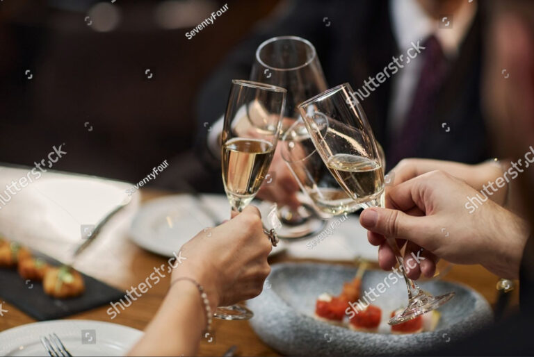 stock-photo-close-up-of-adult-friends-clinking-champagne-glasses-during-restaurant-dinner-celebrating-social-2772737959